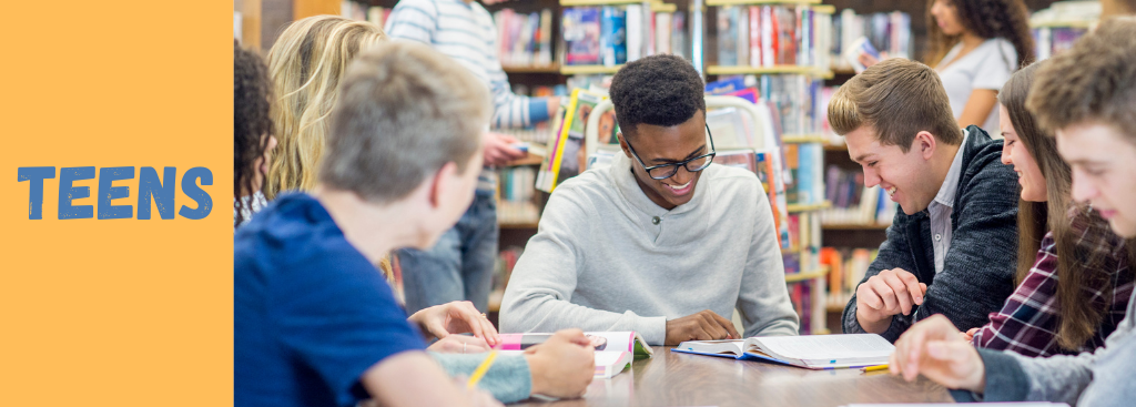 Teens: Teens sitting on a wall reading from books or devices