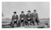 This picture is in the some order as the previous photo except there has been some change in headgear. The figure on the left is Bert Miller.