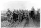 A typical picture of mud spattered Canadians coming out of the line.